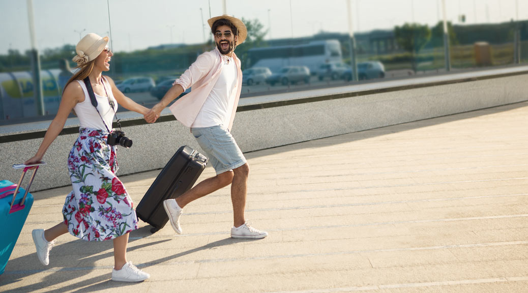 Happy couple walking on airport